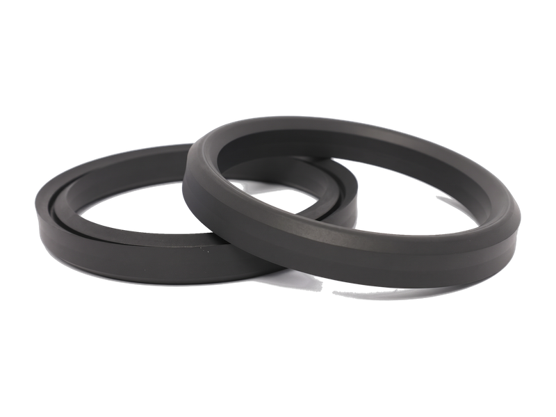 A pair of WSP Extreme® Onyx well service packing rings, shown at an angle.
